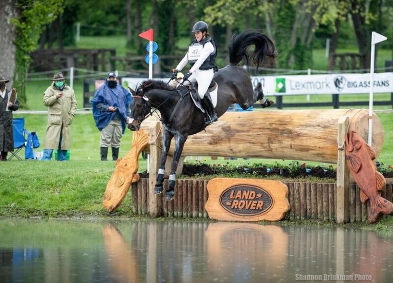 cross country horse jumping large log into water at land rover kentucky